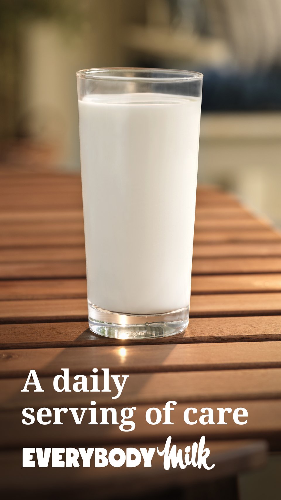 A full glass of milk sitting on a wood table