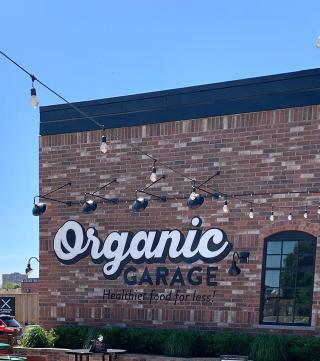 Exterior of Organic Garage, a brick building with outdoor lights and shrubs