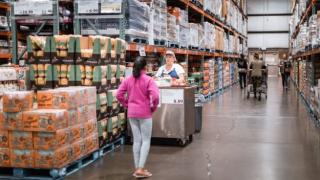 Costco wholesale warehouse shopping aisle with food testing