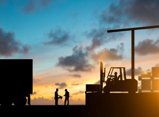 Silhouette inspector are examining the waybill with the Forklift and truck bringing up the goods in warehouses Business Logistics and Transportation over blurred natural background sunset pastel.