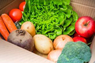 Cardboard delivery box filled with fresh fruit and vegetables