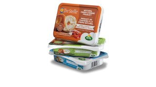 Packs of Tre Stelle cream cheese stacked on top of one another