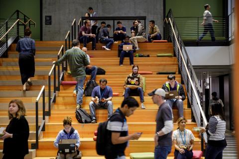 Amazon workers sitting on a set of stairs at the company's campus in Seattle