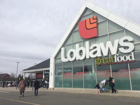 People line up in front of Loblaws grocery store during Ontario 3rd wave lockdown in Toronto, Canada