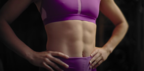 A female wearing workout gear that exposes her abs