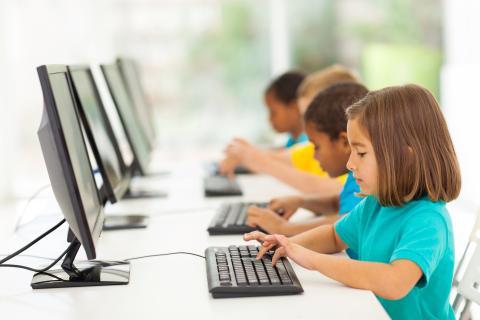 A group of elementary school students in computer class