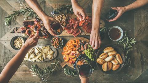 A wooden table filled with holiday dishes