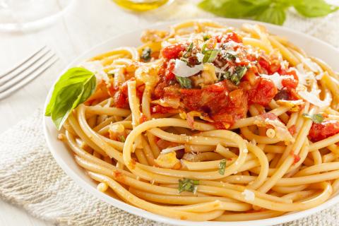 Homemade Bucatini Amatriciana Pasta with sauce and basil