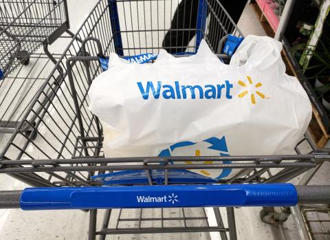 Branded Walmart shopping cart and bag in Walmart store.