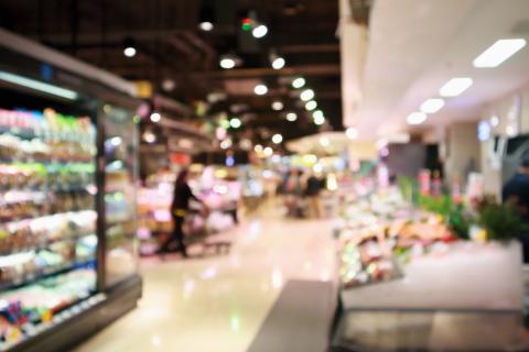 Abstract supermarket grocery store blurred defocused background with bokeh light