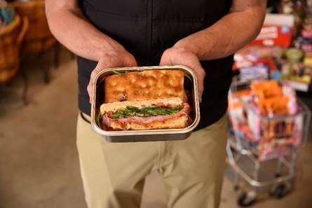 IGA Resuables.com stainless steel container holding a sandwich