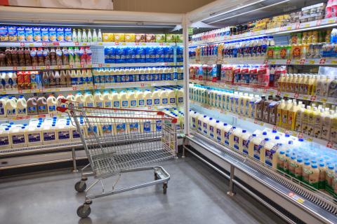 Fresh Milk Bottles On Supermarket Stand.