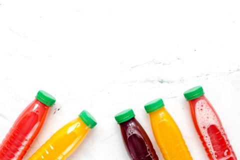 vegetable juice in plastic bottle on white table top view mock up