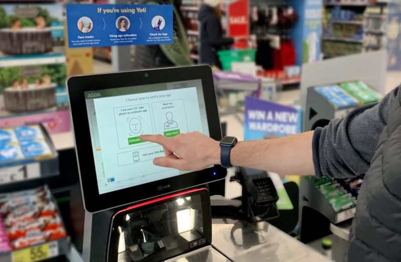 A man using the identification technology at an Asda self-checkout kiosk