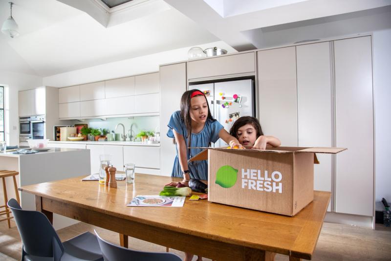 Two children unboxing a HelloFresh meal kit