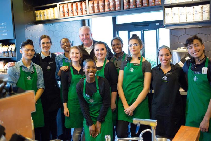 Kevin Johnson in a Starbucks store with baristas