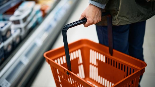 hand holding empty grocery basket