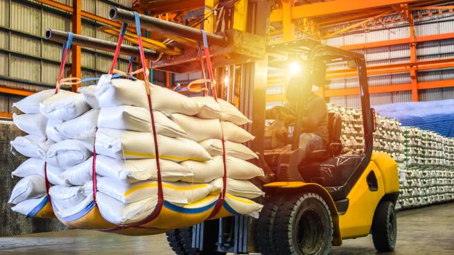 Forklift handling sugar bag for stuffing into container for export. Distribution, Logistics Import Export, Warehouse operation, Trading, Shipment,